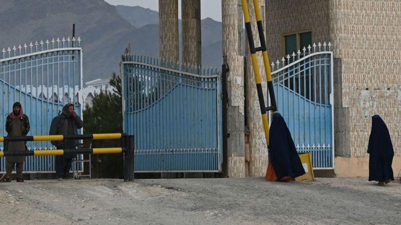 طالبات يدخلن جامعة لغمان في حين يقف عناصر طالبان حراسا على الباب