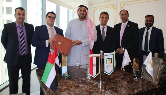 خلال توقيع عقد الشراكة بين البنك الأهلي ومجموعة إم بي إف الإماراتية