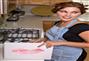 Pretty young woman prepares dinner in her kitchen