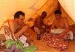 مستجمون يشربون الشاي داخل خيمة تستخدم للاسترخاء بعد حمام الرمل الساخن في سيوة                                                                                                                           