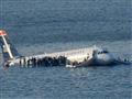 US-Airways-plane-as-a-ferry-pulls-up-to-it-after-it-landed-in-the-Hudson-River-in-New-York