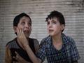 زيد وحذيفة، يواسيان بعضهما بعد انهيار منزلهما في الموصل، يوم 24 يونيو                                                                                                                                   