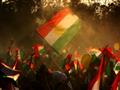 أكراد عراقيون يرفعون أعلاما كرديا خلال تجمع في 15 