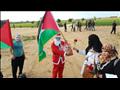 فلسطيني يوزع ورود على حدود غزة بملابس سانتا كلوز (
