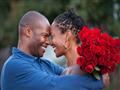 Man-hugging-wife-and-giving-her-red-roses
