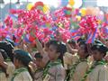 اطلاب يحملون زهورًا وأعلامًا كمبودية خلال الاحتفالات بالذكرى الثانية والستين لاستقلال البلاد عن فرنسا في عام 2015.