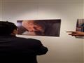 خالد جلال أمام صورة محمد خان في المعرض                                                                                                                                                                  