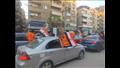 المشاركين في مسيرة سوهاج يرفعون أعلام مصر