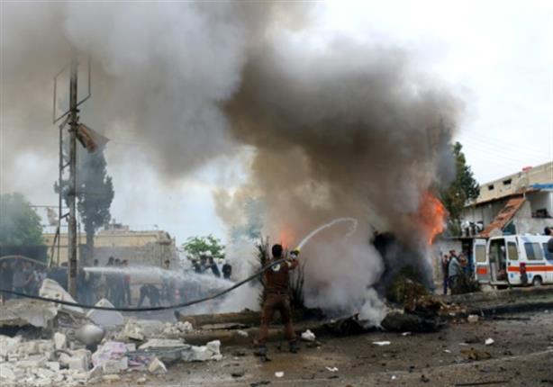 A member of the Syrian civil defence tries to exti