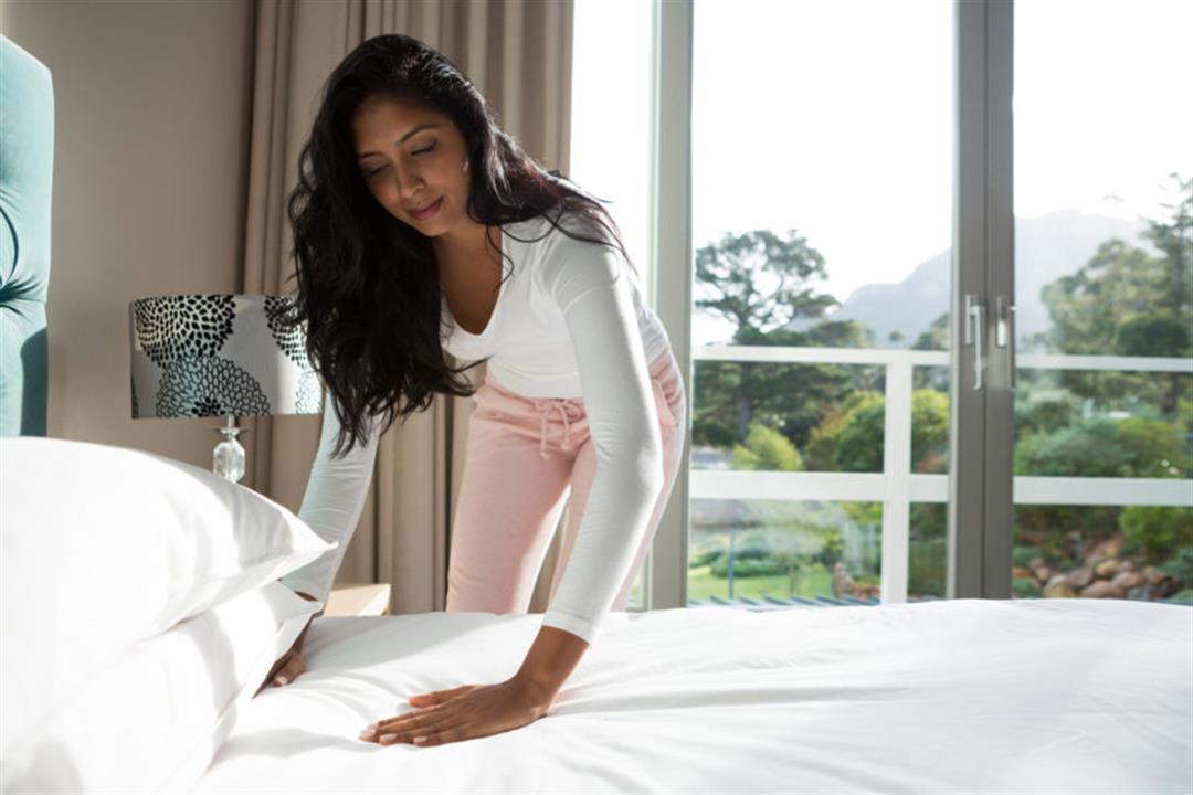 woman-making-bed-e1520805967469-870x580