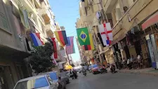 مقاهي البحيرة تتزين بأعلام الدول المشاركة استعدادًا لمباراة مصر وبلجيكا (صور)