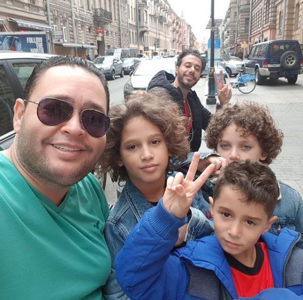 أحمد رزق مع أولاد الثلاثة وبخلفية الصورة أحمد السع