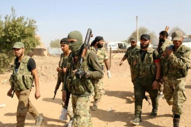 مقاتلون سوريون موالون لأنقرة أثناء تواجدهم على أطر