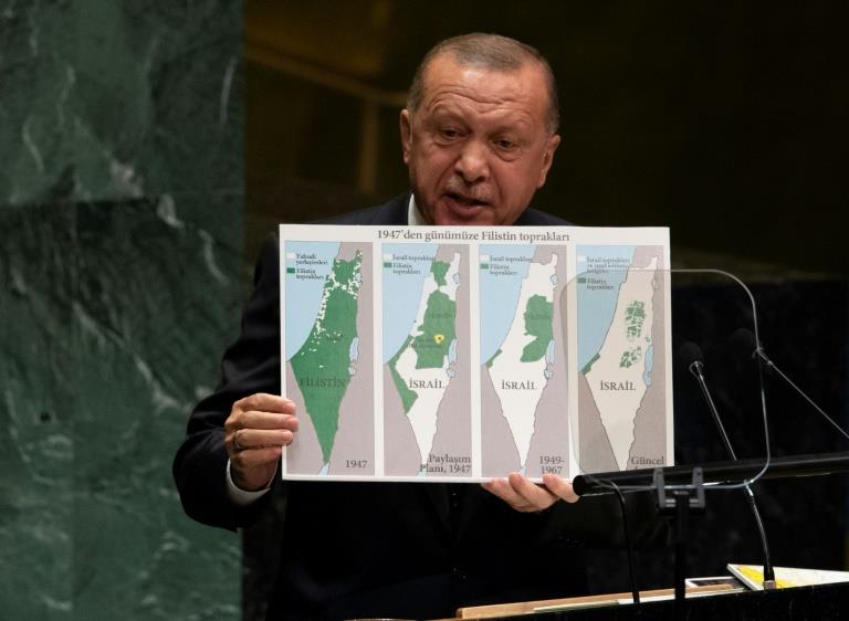 الرئيس التركي رجب طيب أردوغان يحمل خريطة فلسطين ال