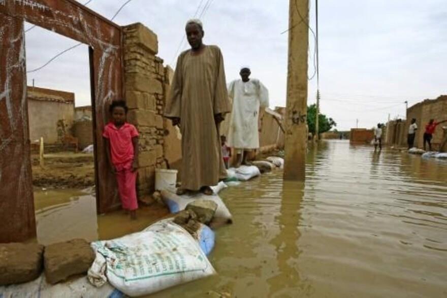 سودانيون يمشون على أكياس من الرمل للوصول إلى منازل