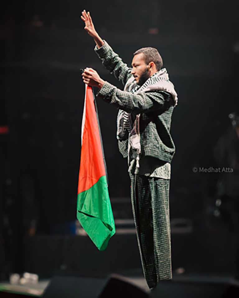ويجز بالشال الفلسطيني ويرفع العلم