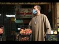 التزام تجار سوق الجملة بأكتوبر بارتداء الكمامات