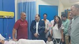 حسام حسن وزوجته في زيارة لمرضى مستشفى العجمي 