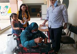 على مقاعد متحركة.. معاقون يدلون بأصواتهم في انتخابات مجلس النواب بالفيوم -صور