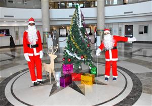 بزي بابا نويل.. طفلان يوزعان الهدايا على نزلاء مستشفى شفاء الأورام